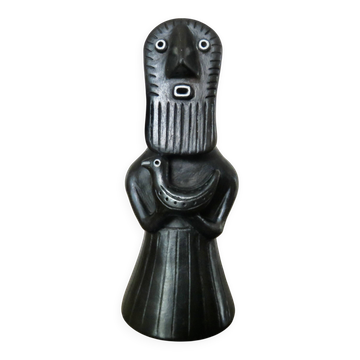 Matte black ceramic sculpture representing a female tribal figure.