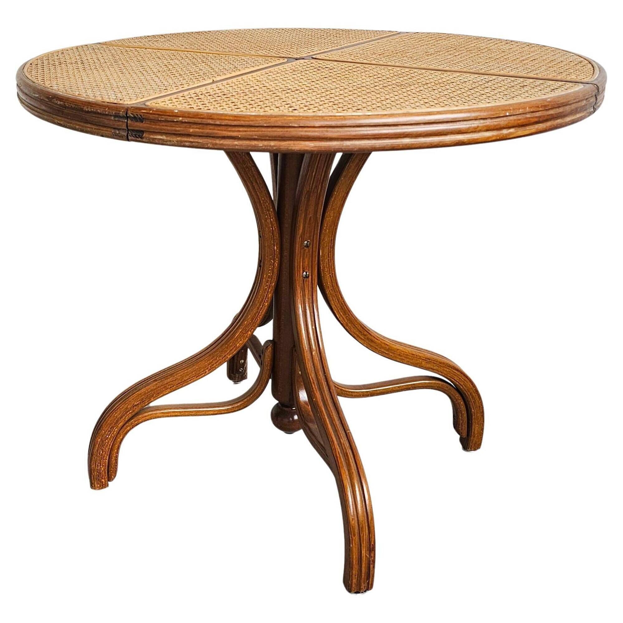 Round dining table in curved wood with a rattan top by Mundus, 1960s.