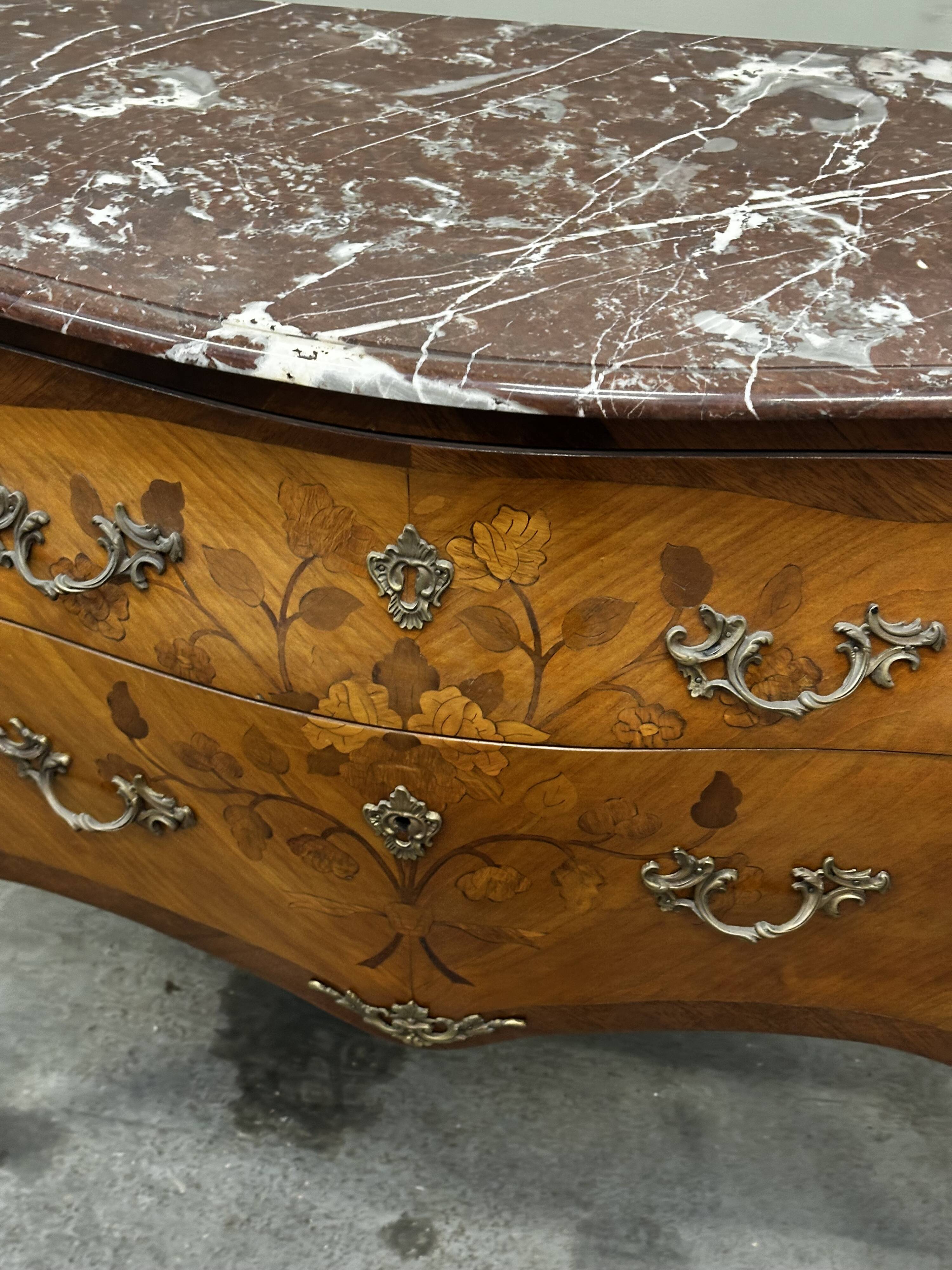 Curved and inlaid Louis XV style chest of drawers