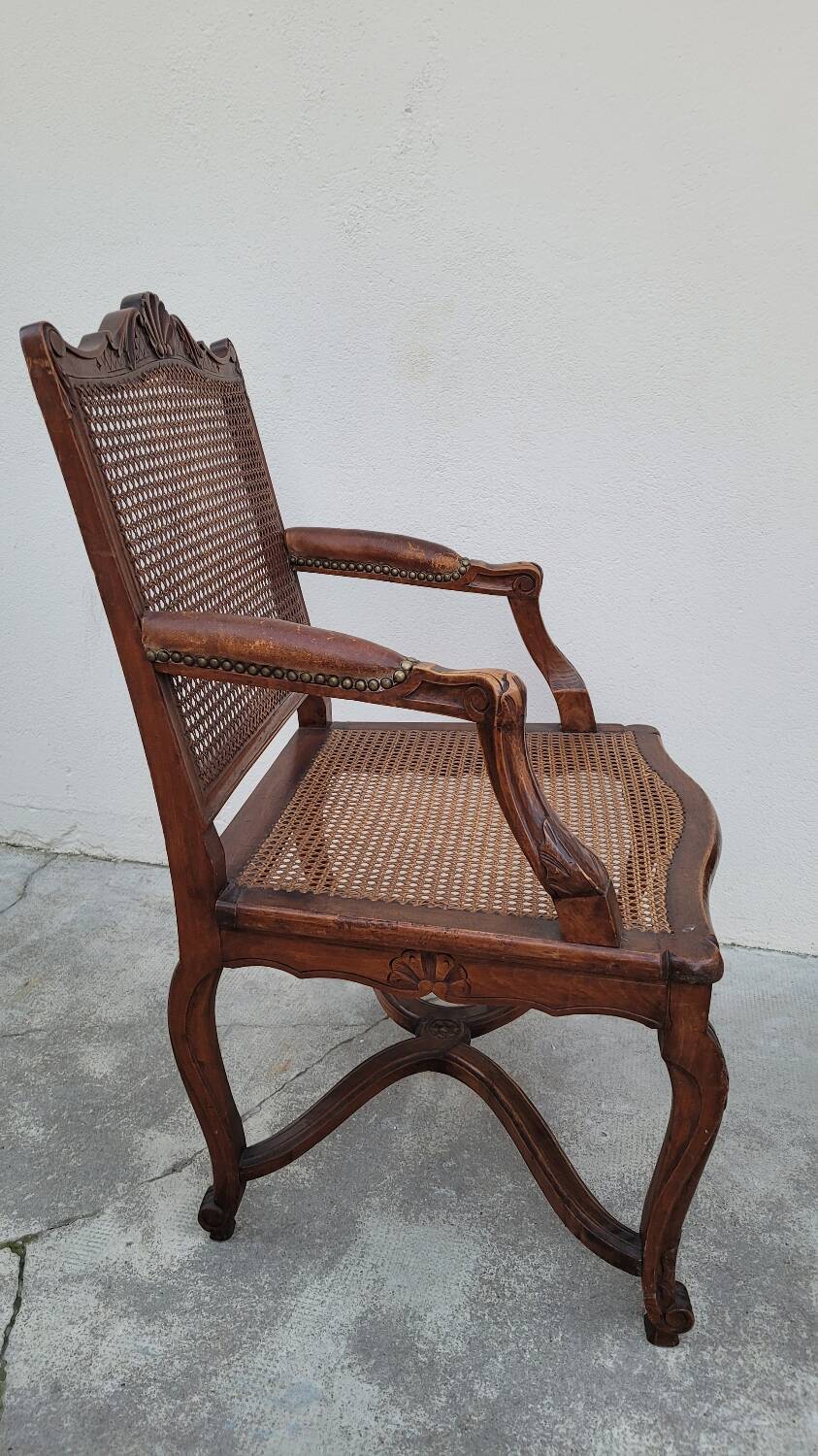 Louis XV Regency cane armchair leather armrests decorated with shell