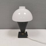 Small stylish table lamp with perforations and milky white opal glass shade