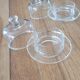 2 transparent glass butter dishes accompanied by their matching cloches.