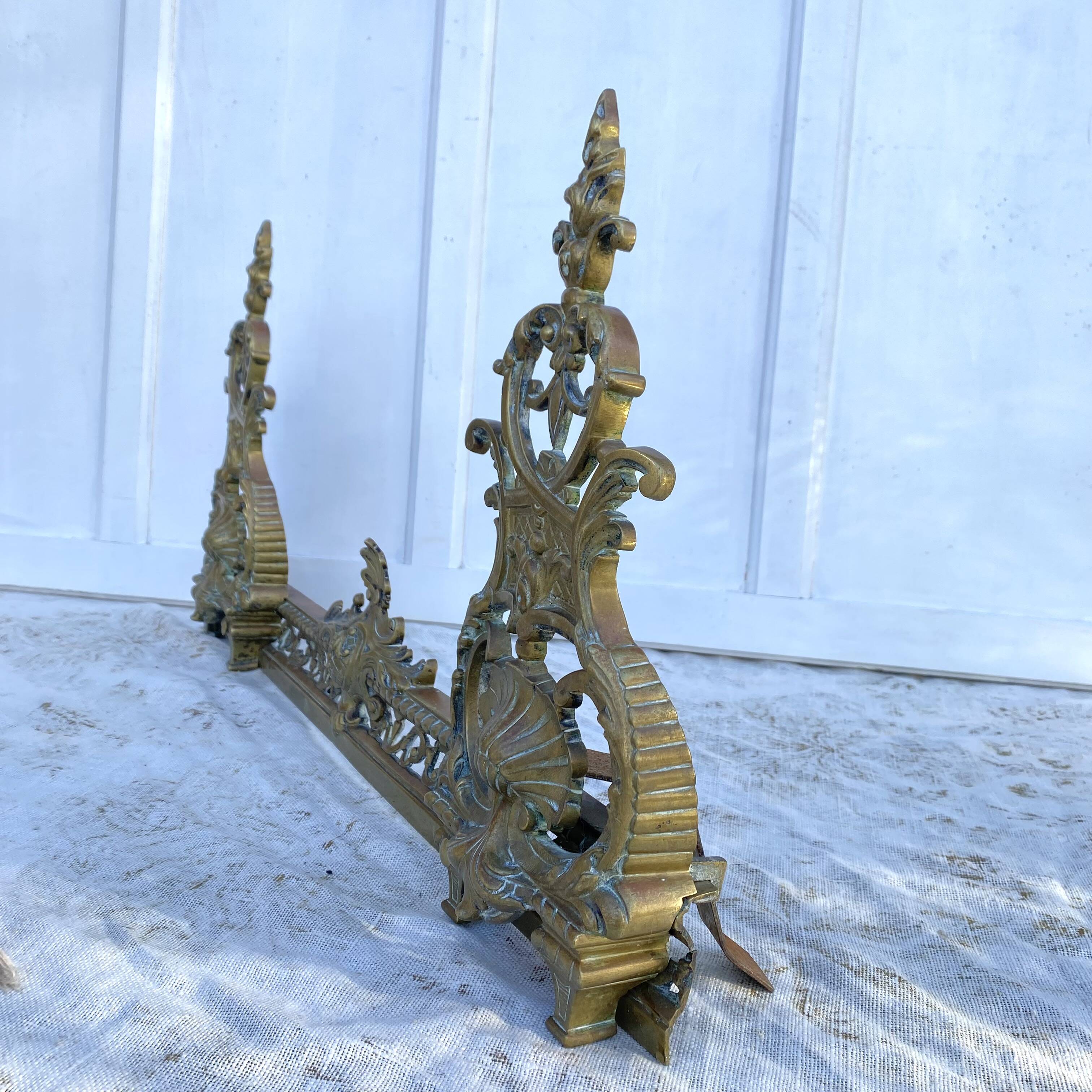 Antique brass fireplace set, bar and andirons, Napoleon I style.