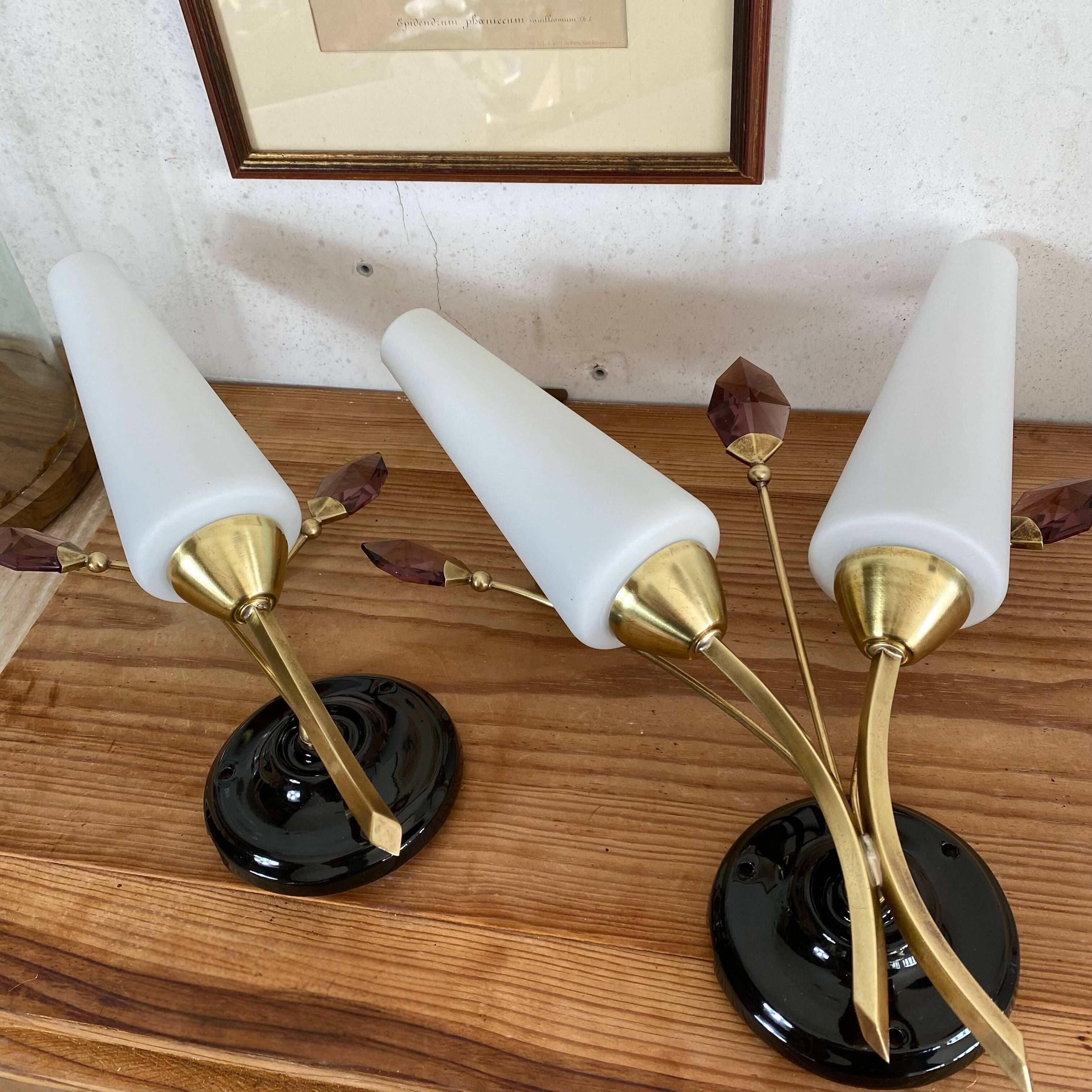 Pair of wall sconces in brass with white glass tulips.