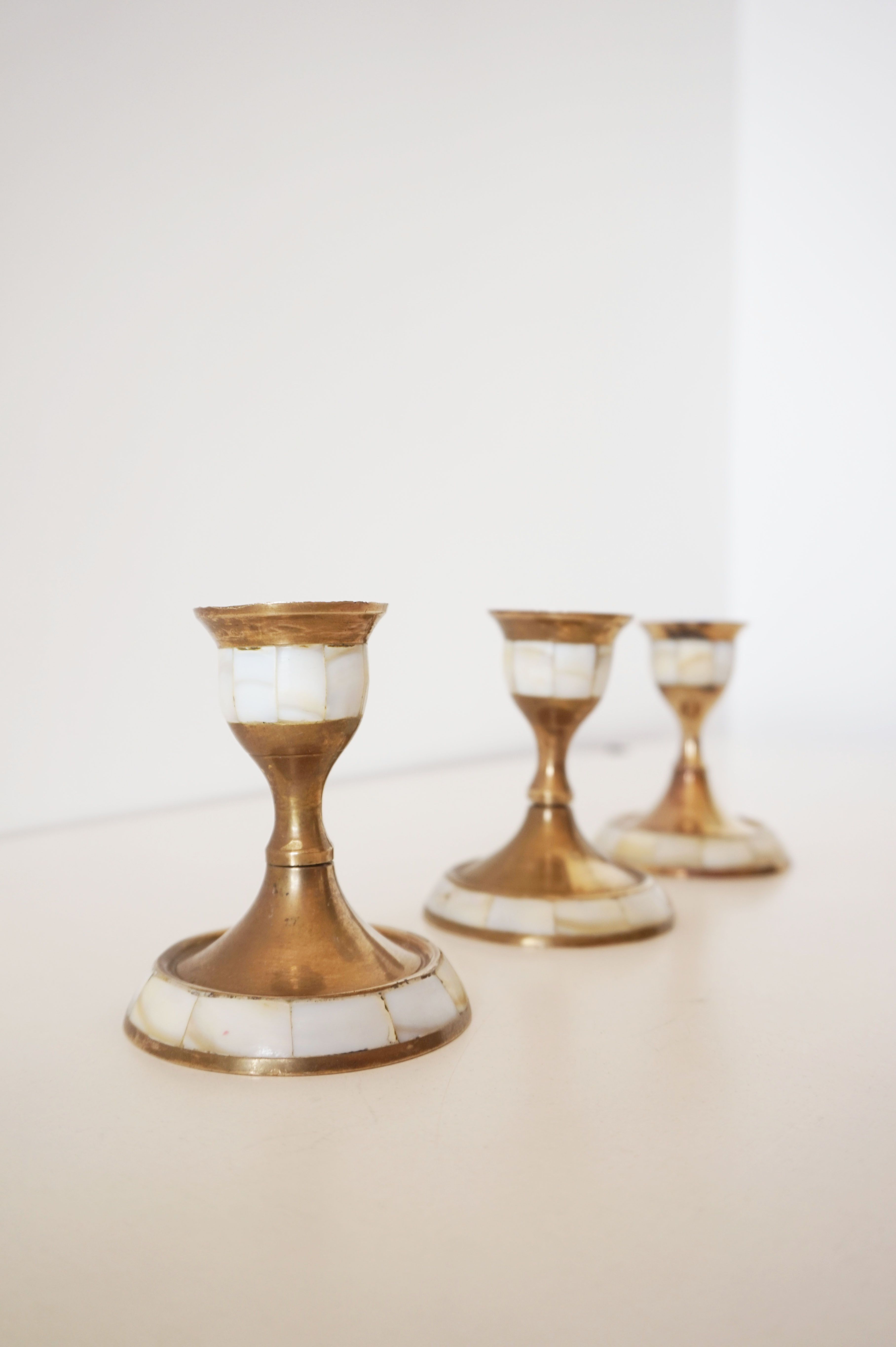 Lot of old candlesticks in brass and mother-of-pearl