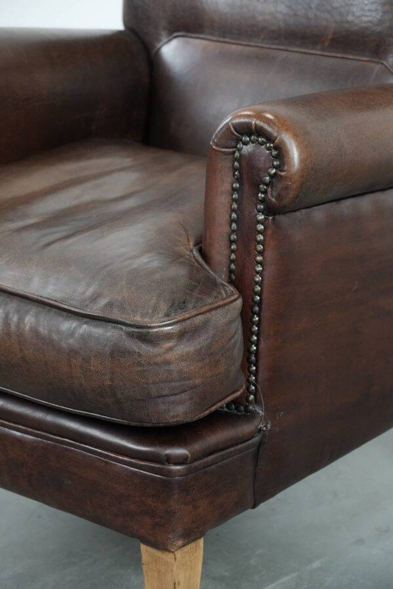Characterful sheep leather armchair with a beautiful deep colour