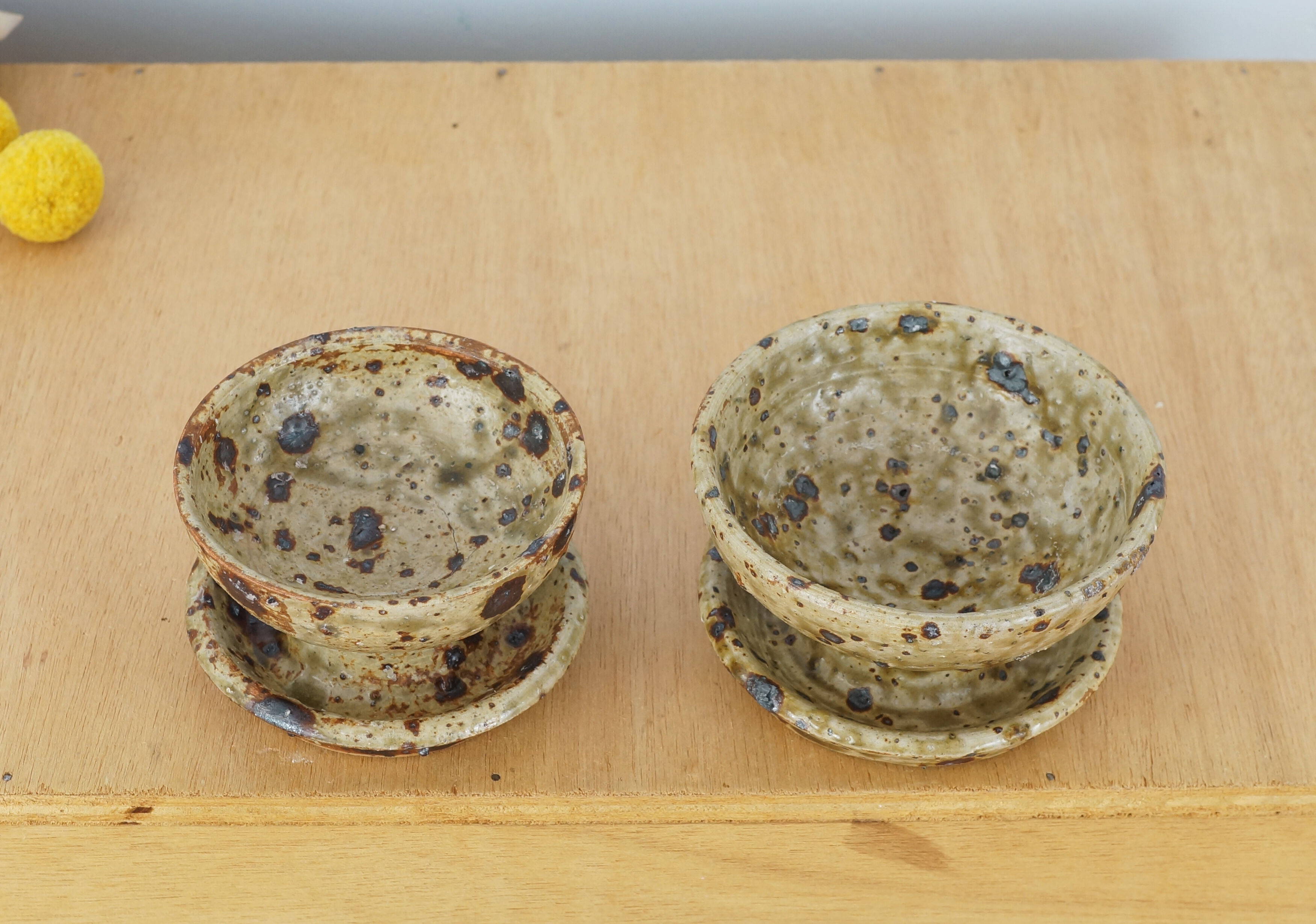 Pair of vergy speckled sandstone candle holders, vintage