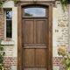 Old solid oak front door with frame and transom from the 19th century.