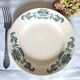 Mismatched antique flat plates made of ironstone pottery.