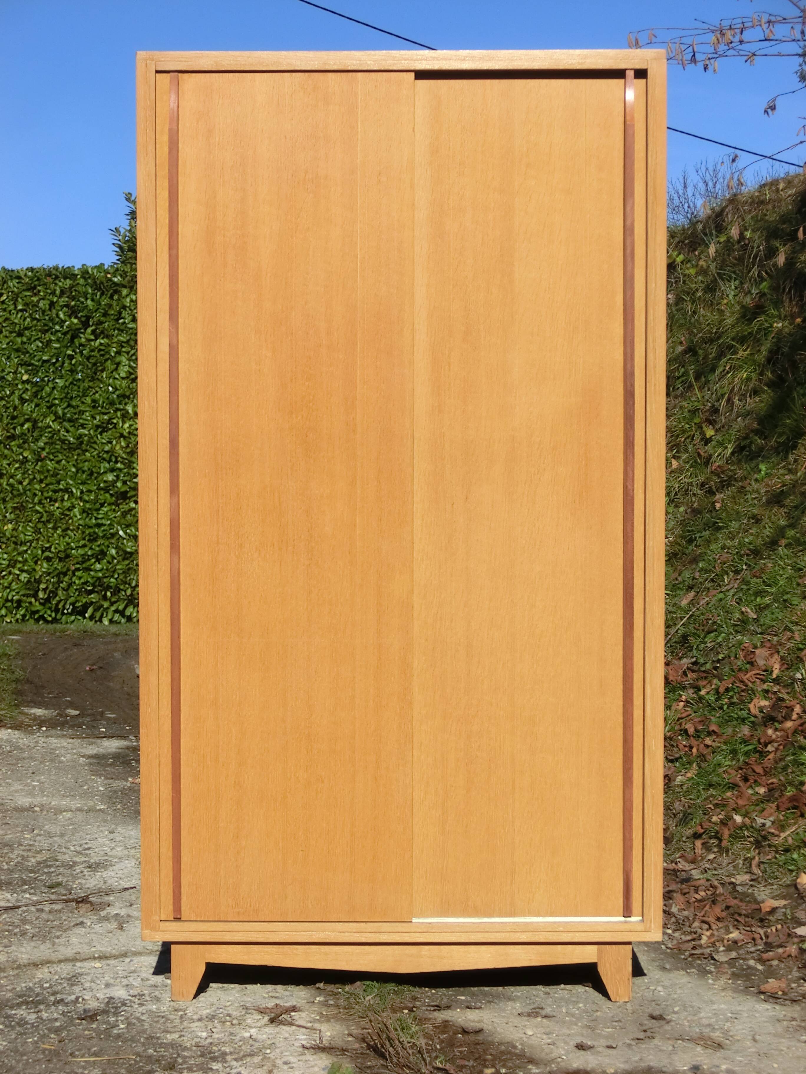 Small Scandinavian wardrobe with sliding doors - 1 side for hanging clothes.