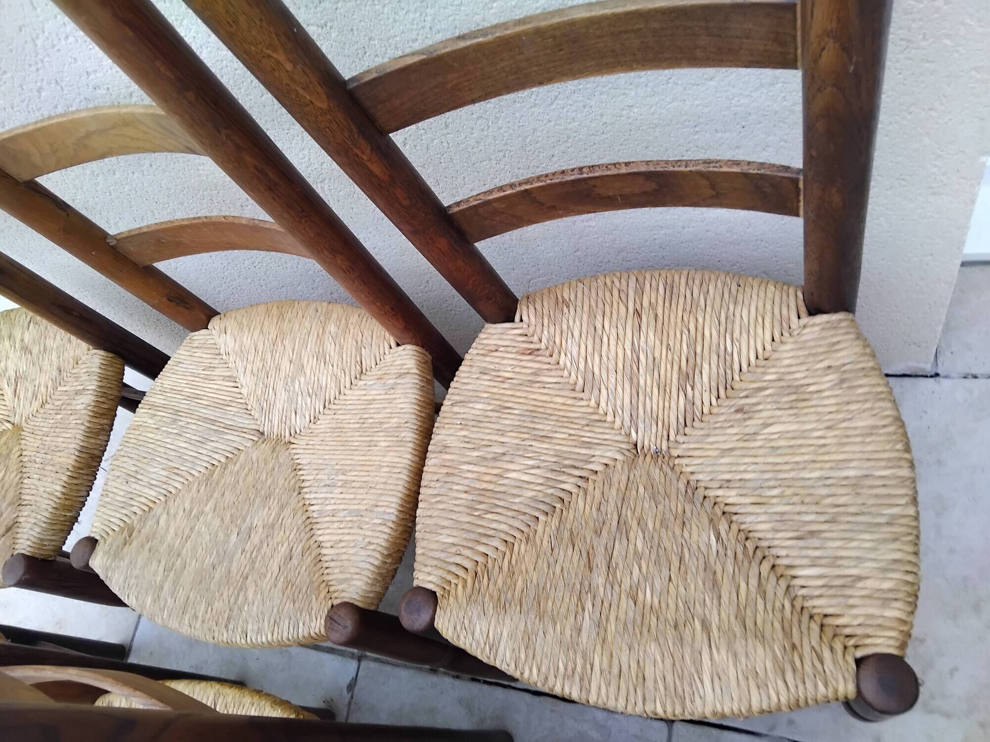 8 vintage straw chairs in the style of Charlotte Perriand.