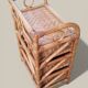 Small storage unit / freestanding shelf in light rattan.