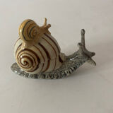 Porcelain figurine snail and its small