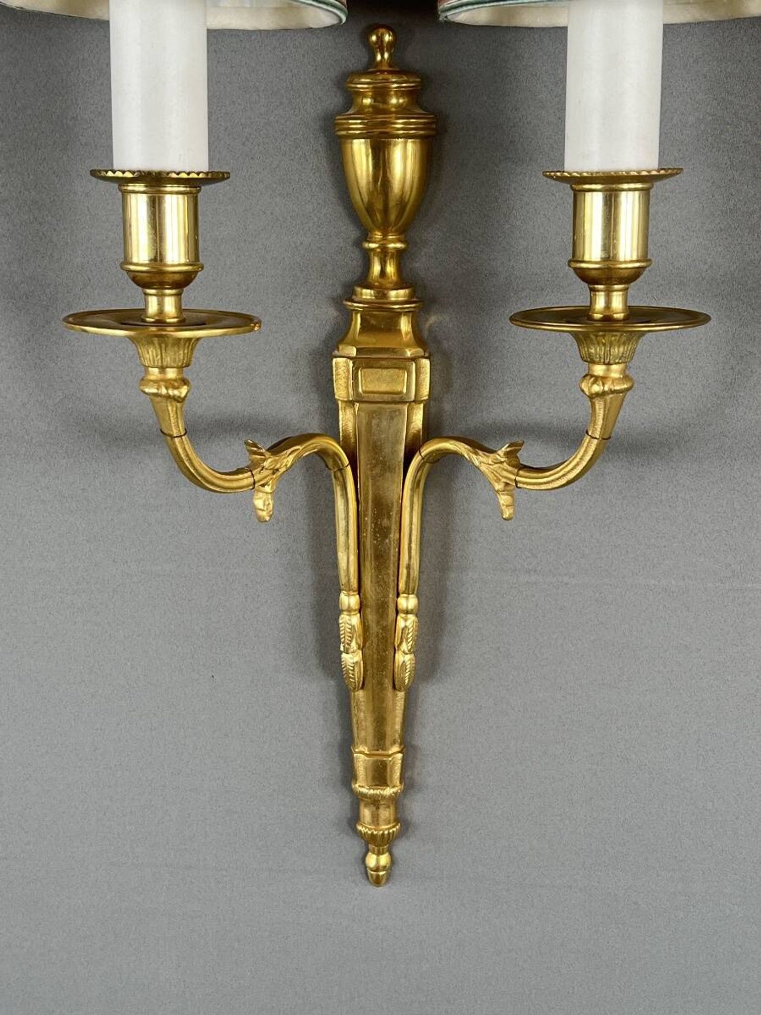 Set of three Louis XVI style wall sconces in gilded bronze, 20th century.