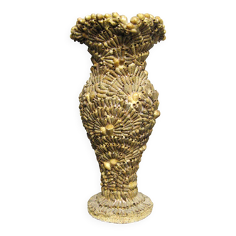 Vase covered with shells. Seaside souvenir.
