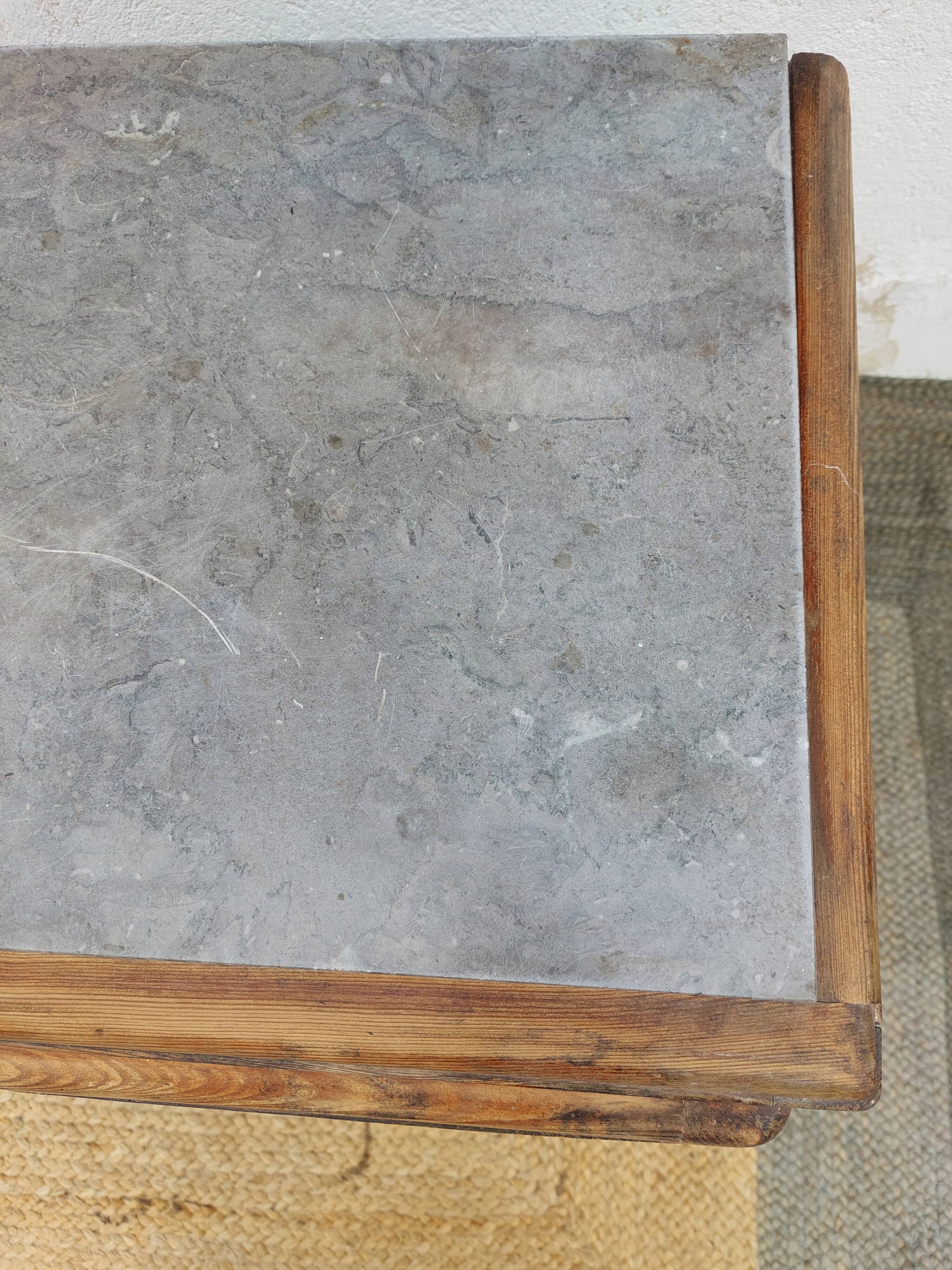 Vintage wooden buffet with a marble top.