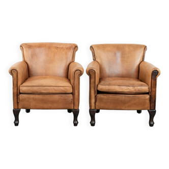 Set of 2 subtle vintage sheepskin armchairs with elegant legs