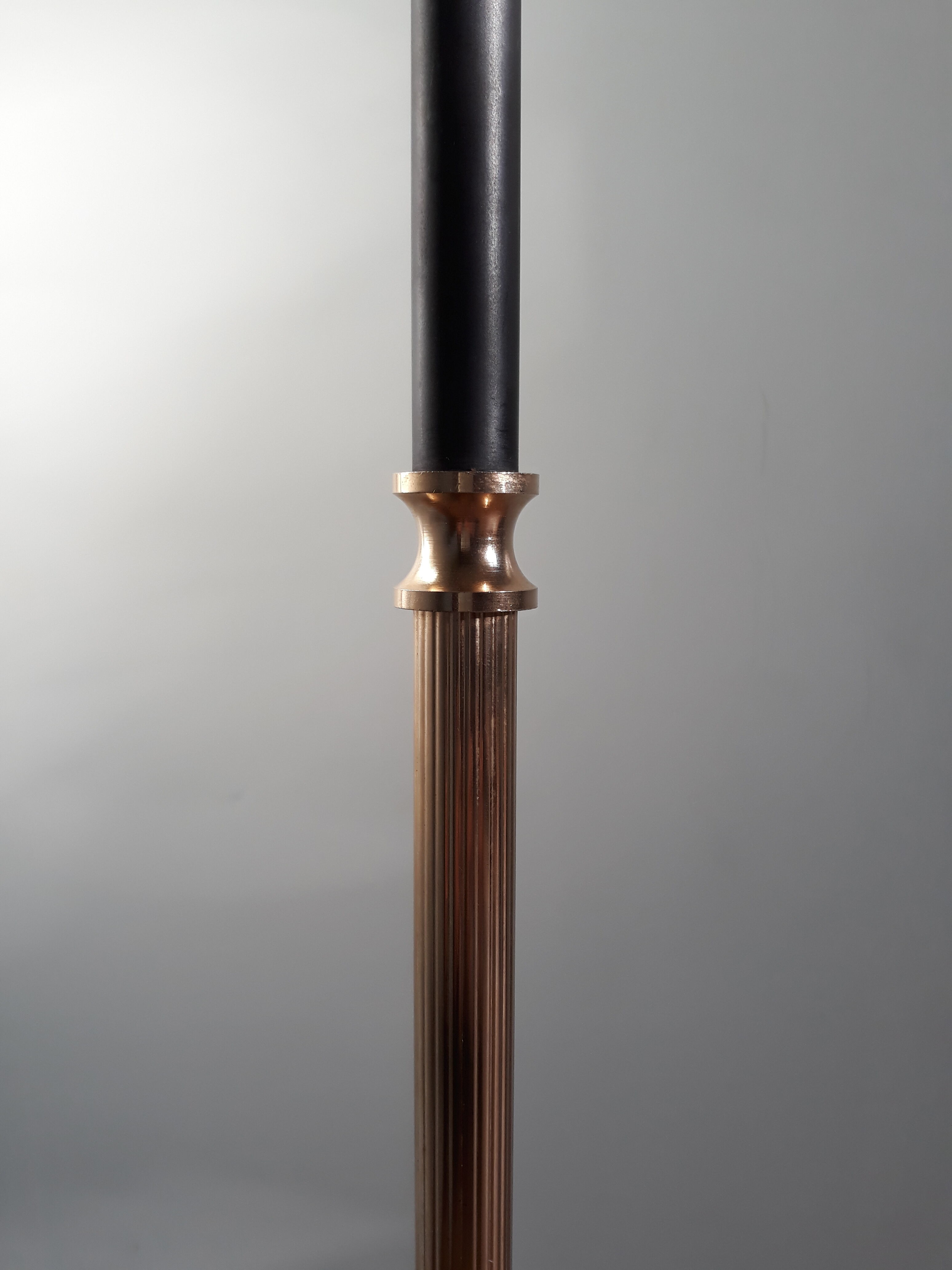 Golden and black tripod floor lamp