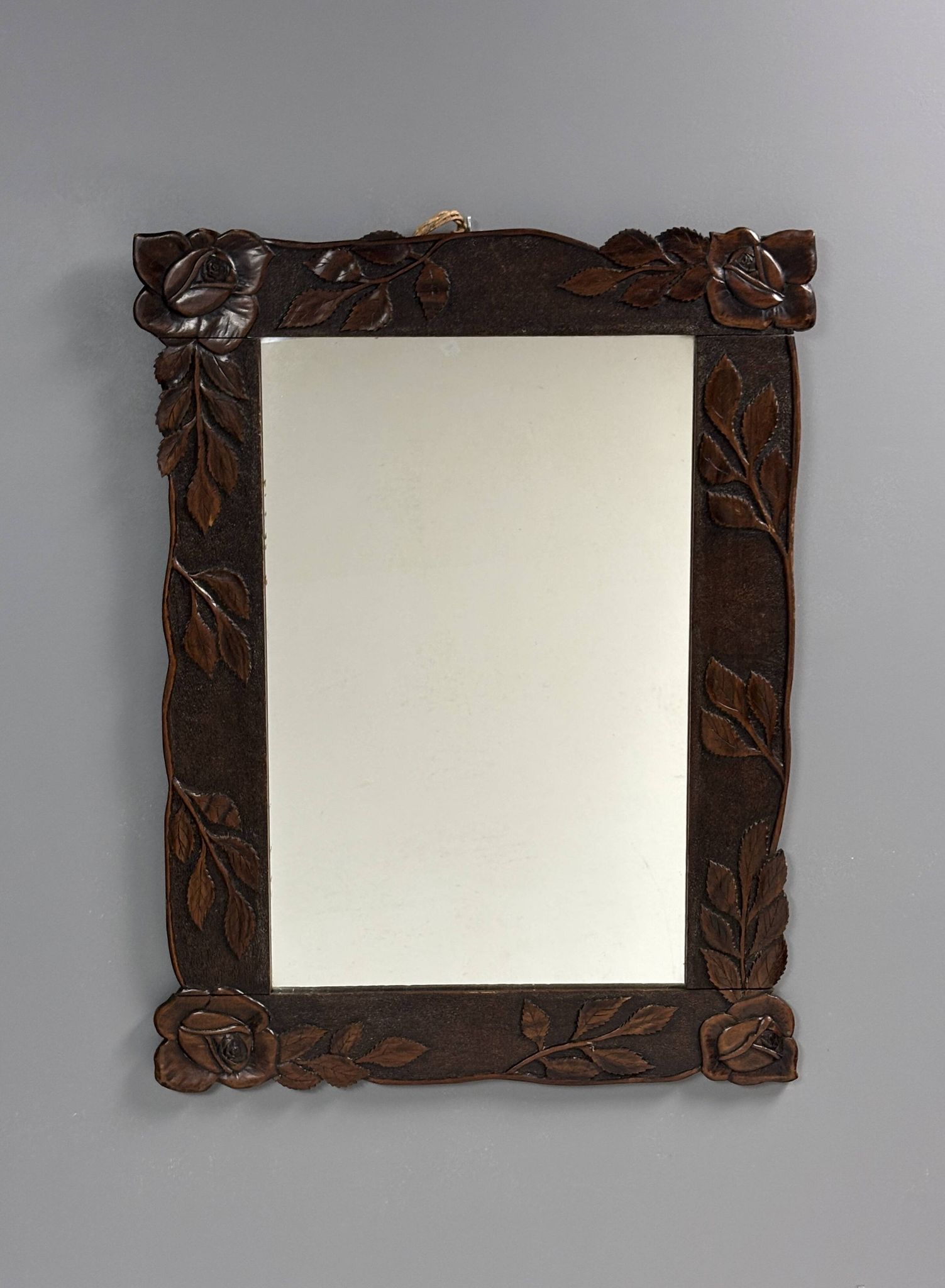 Arts & Crafts hand-carved wall mirror with floral roses, early 20th century