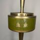 Vintage brass floor ashtray with glass shelf in Empire style.