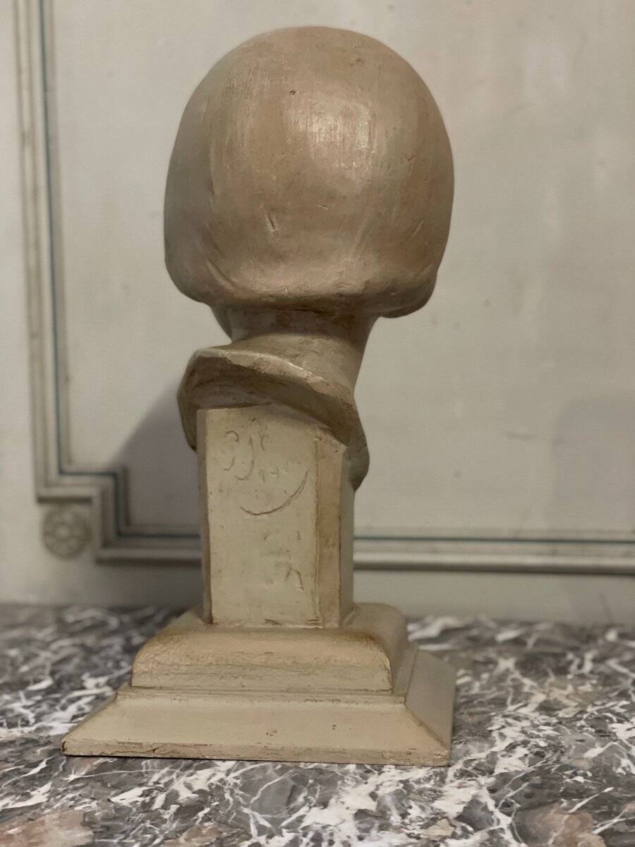 Plaster bust, young girl, monogram and date.