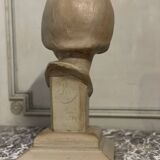 Plaster bust, young girl, monogram and date.