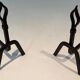 Pair of Modernist Andirons in Wrought Iron with Stylised Torches and Bases Ang