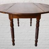 Oval walnut table with flaps