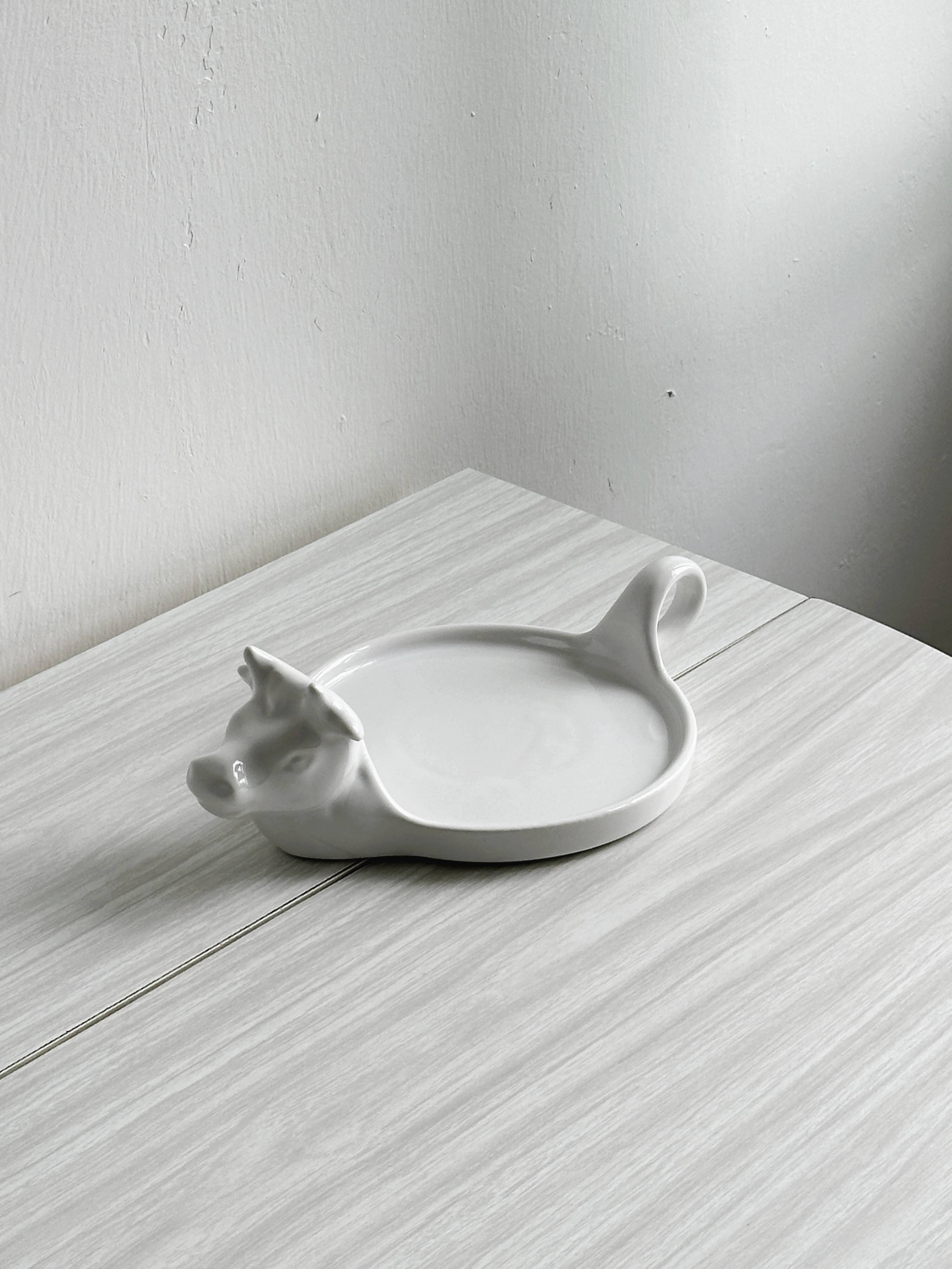 White porcelain cheese dish with handle and cow's head