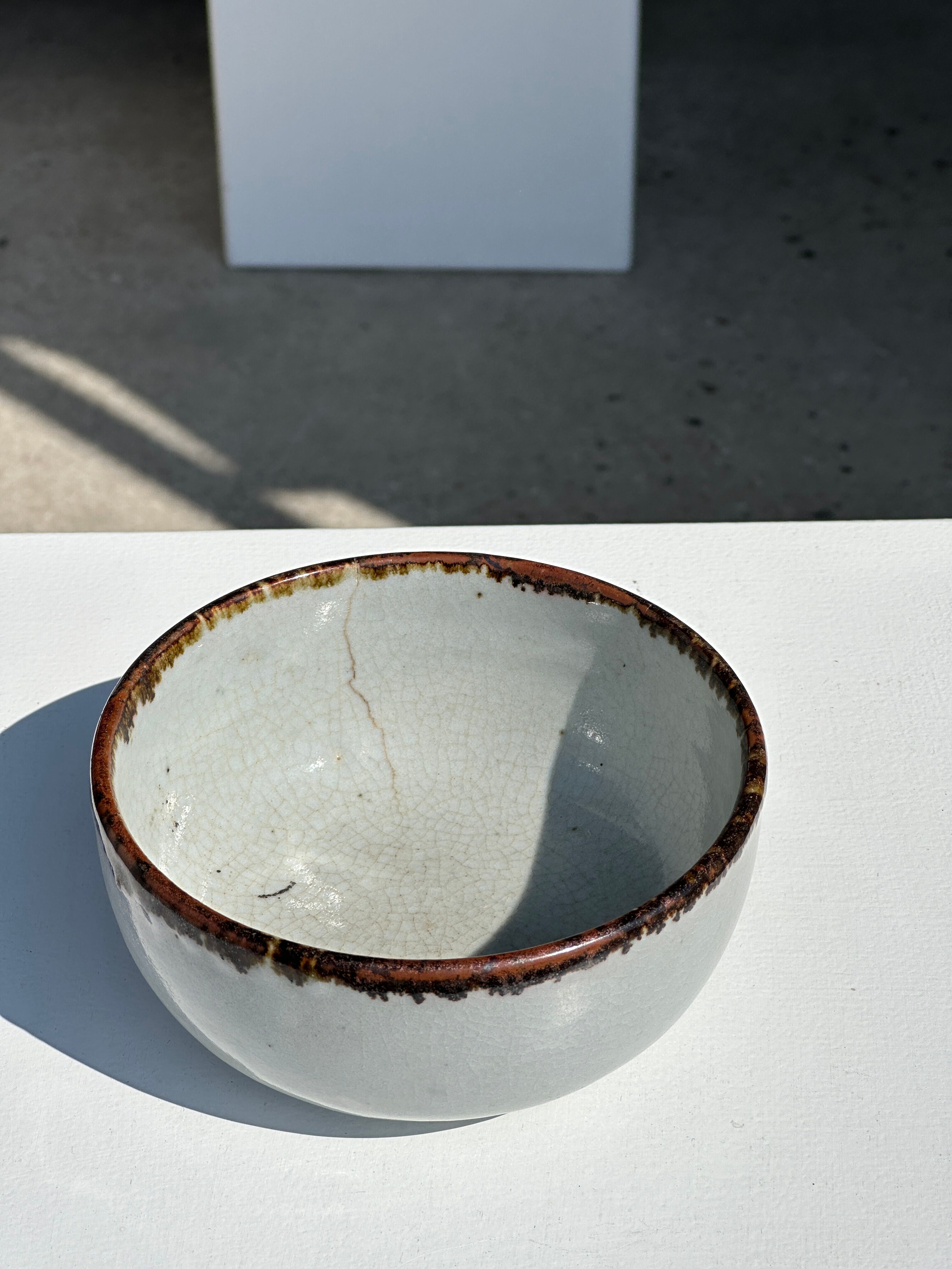 Small white glazed ceramic bowl black edges