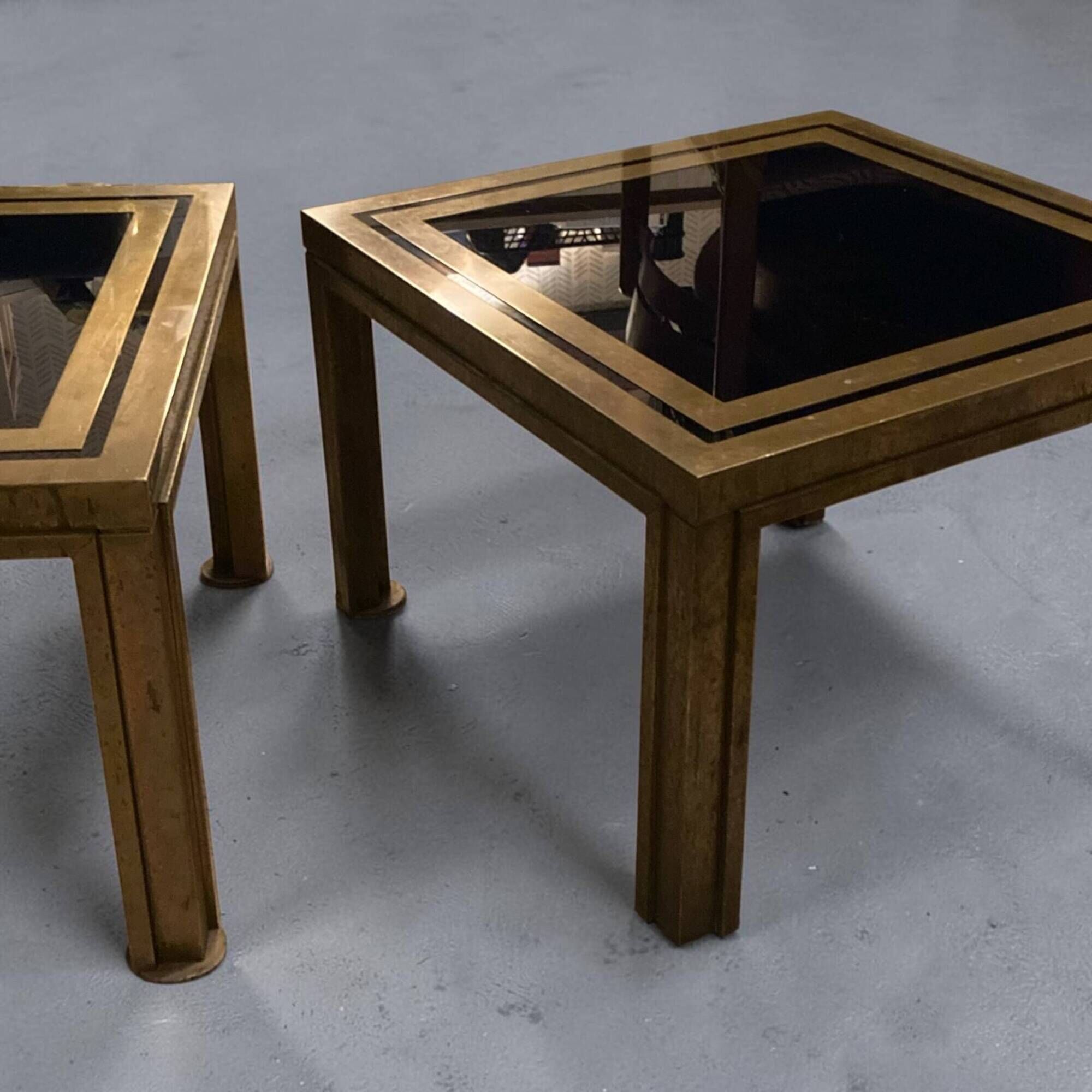Pair of Romeo Rega side tables in brass and smoked glass, Italy 1970.