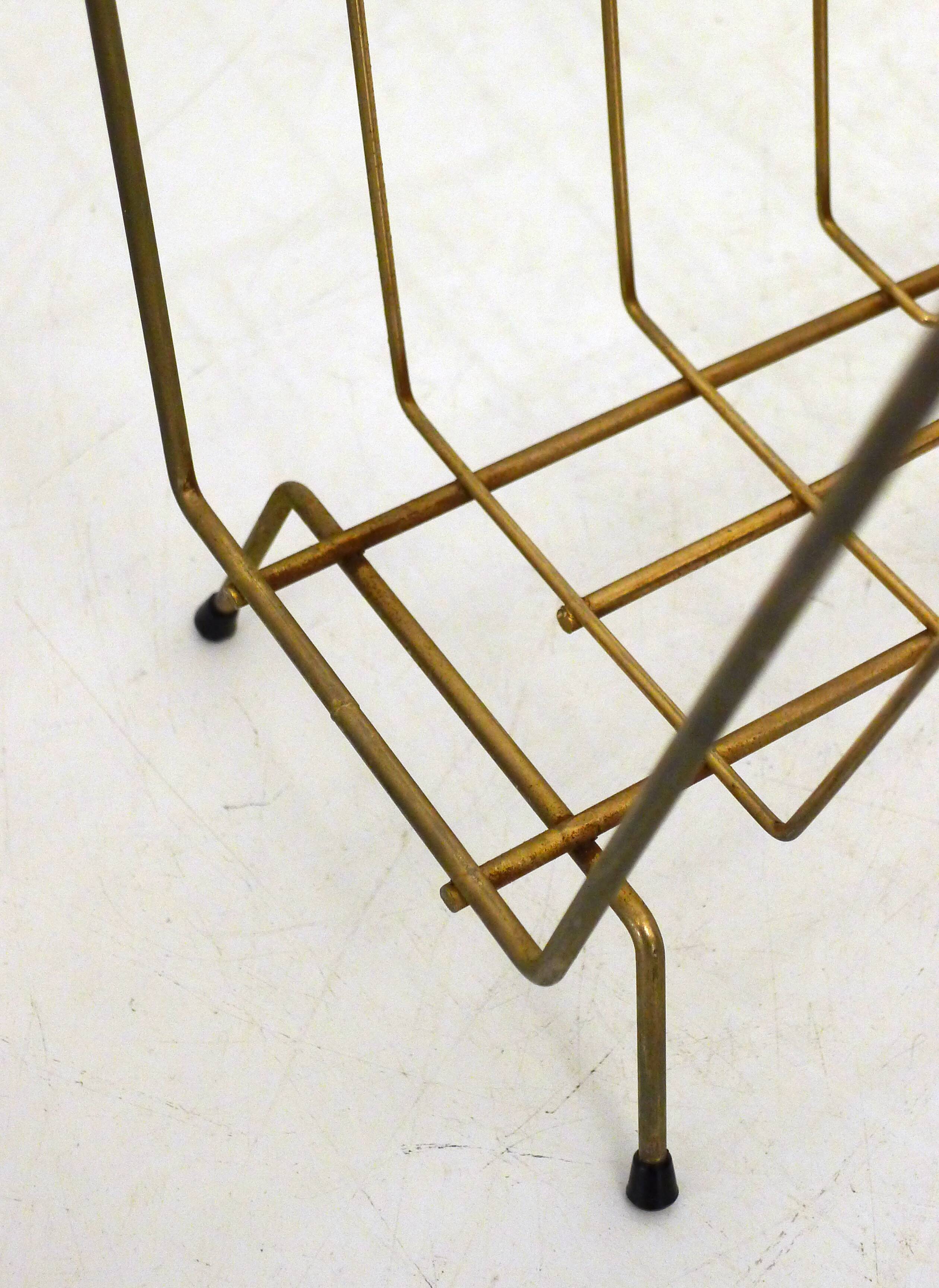 Mid-century openwork magazine rack, in gold metal & wooden handle.