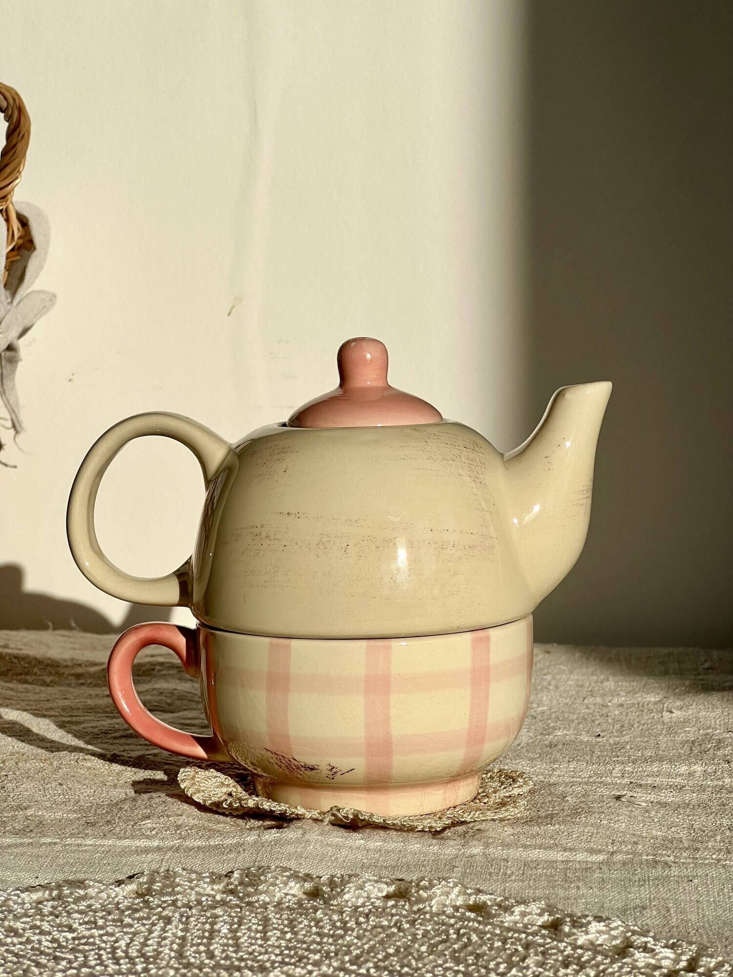 Vintage porcelain teapot and cup set with pink and beige floral and gingham pattern