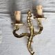 Vintage wall sconce in gold metal with two arms in classic style.