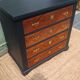 Vintage commode revamped in matte black & wood with warm tones.