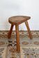 Antique wooden tripod stool – rustic half-moon seat