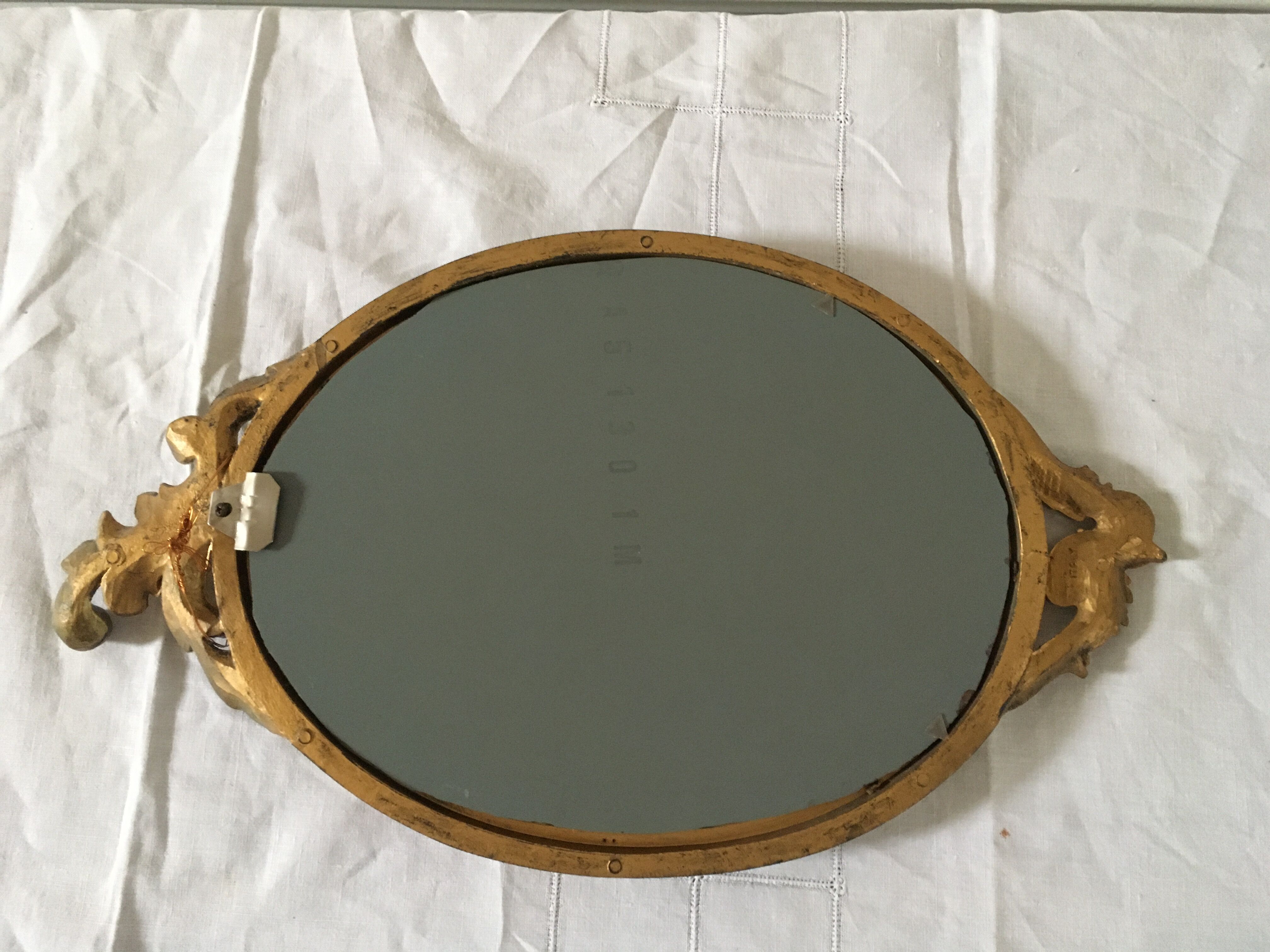 Golden oval mirror