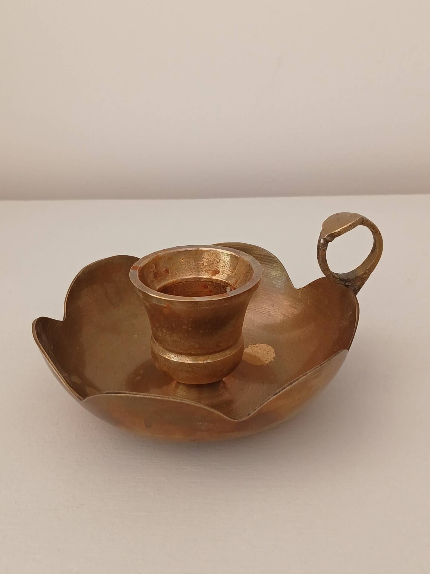 Brass candle holder in the shape of a flower.