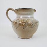 Glazed ceramic jug with plant decoration
