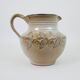 Glazed ceramic jug with plant decoration