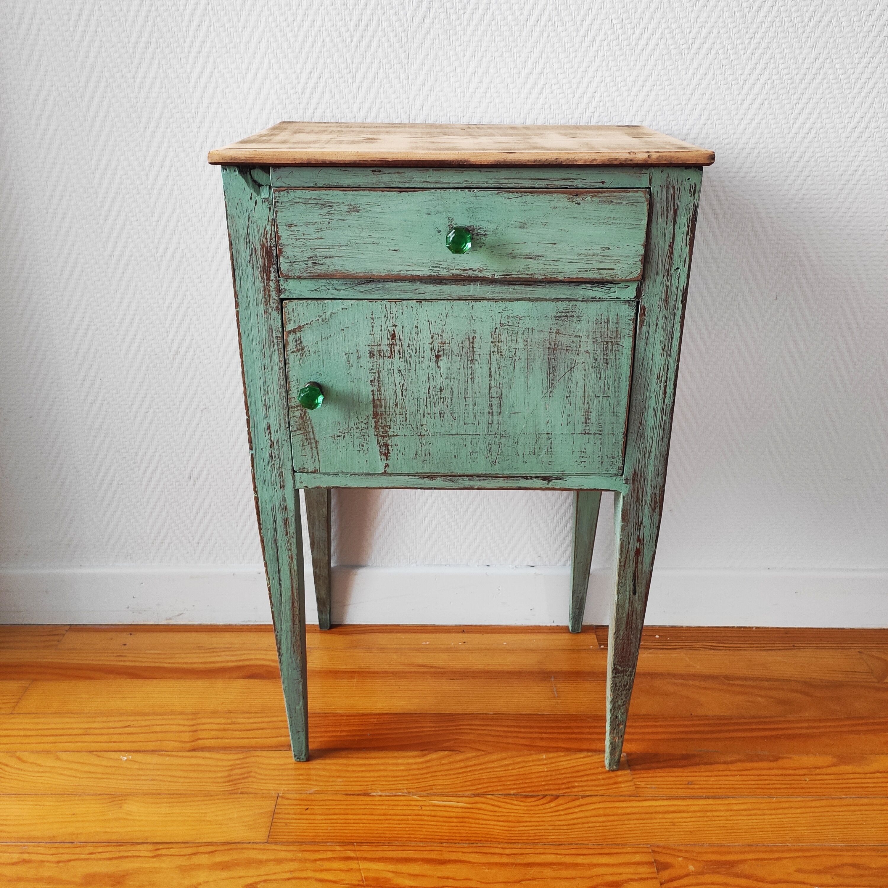 Patinated bedside table end of sofa