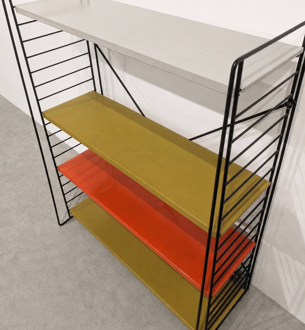 Vintage metal Tomado shelf to place