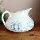 Old bulbous jug in ironstone earthenware