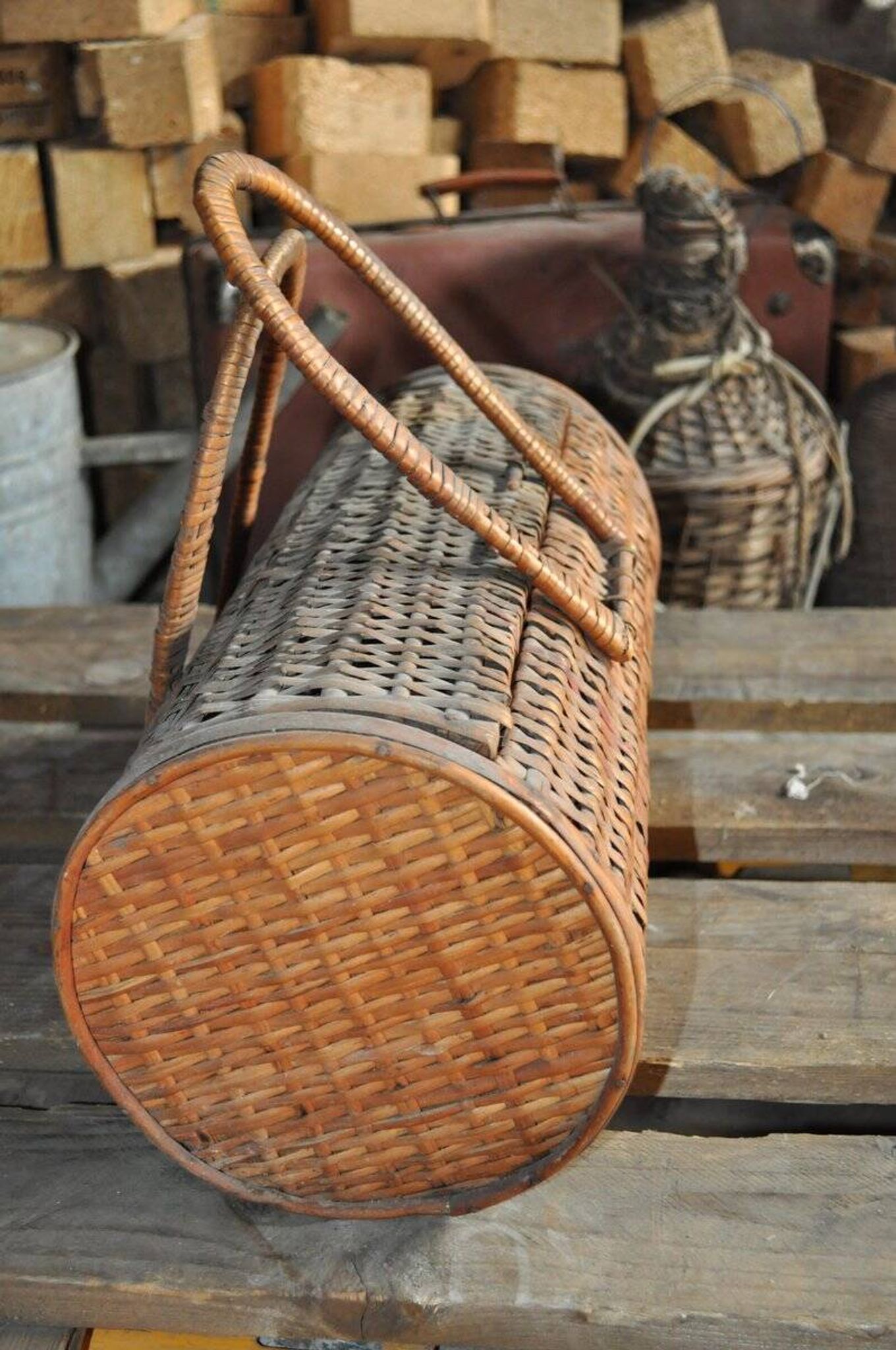 Vintage brown wicker cylindrical basket from the 1940s — long case for a bottle