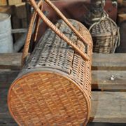 Vintage brown wicker cylindrical basket from the 1940s — long case for a bottle