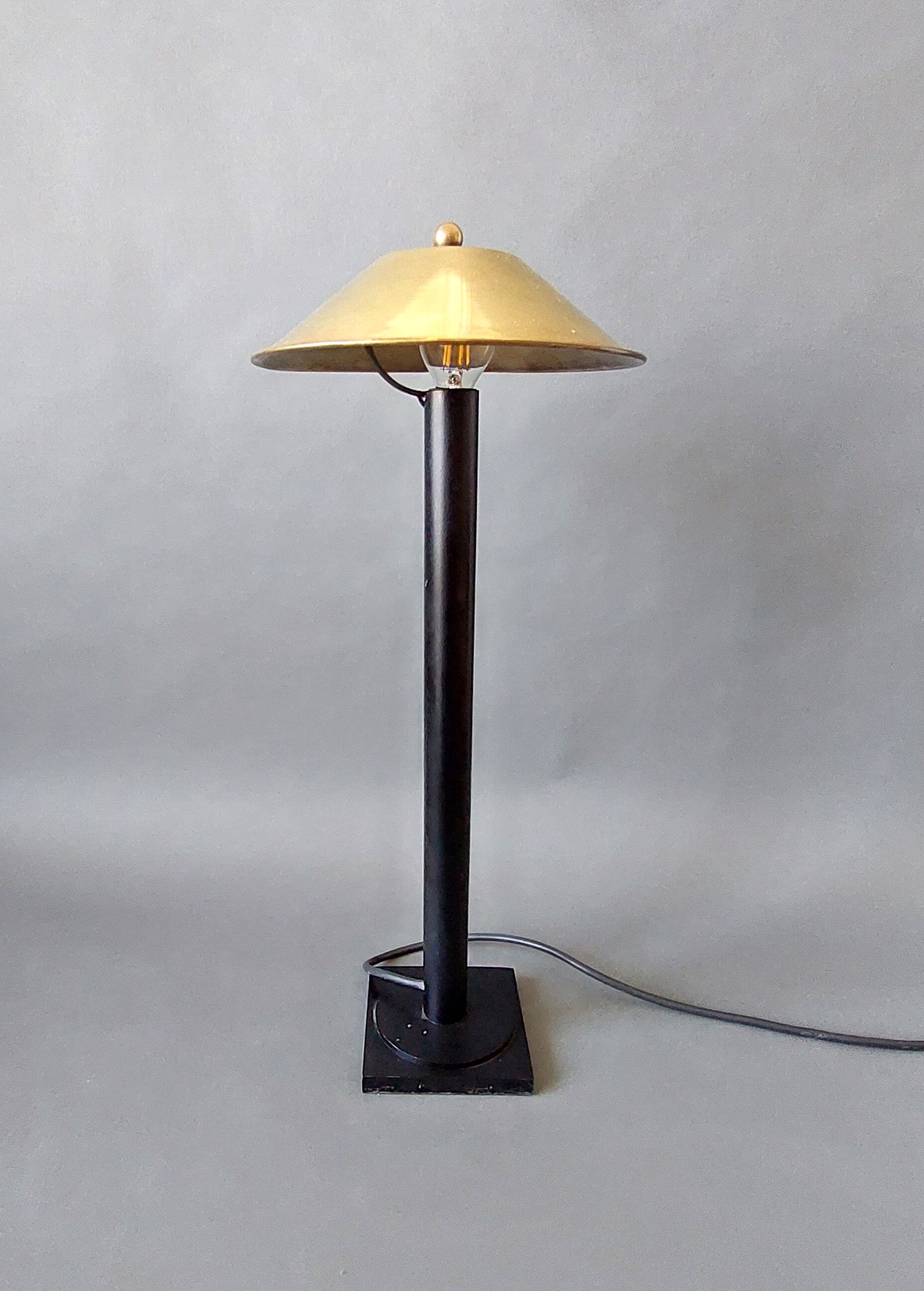 Post-Modern lamp in black metal and gilded brass.