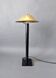 Post-Modern lamp in black metal and gilded brass.