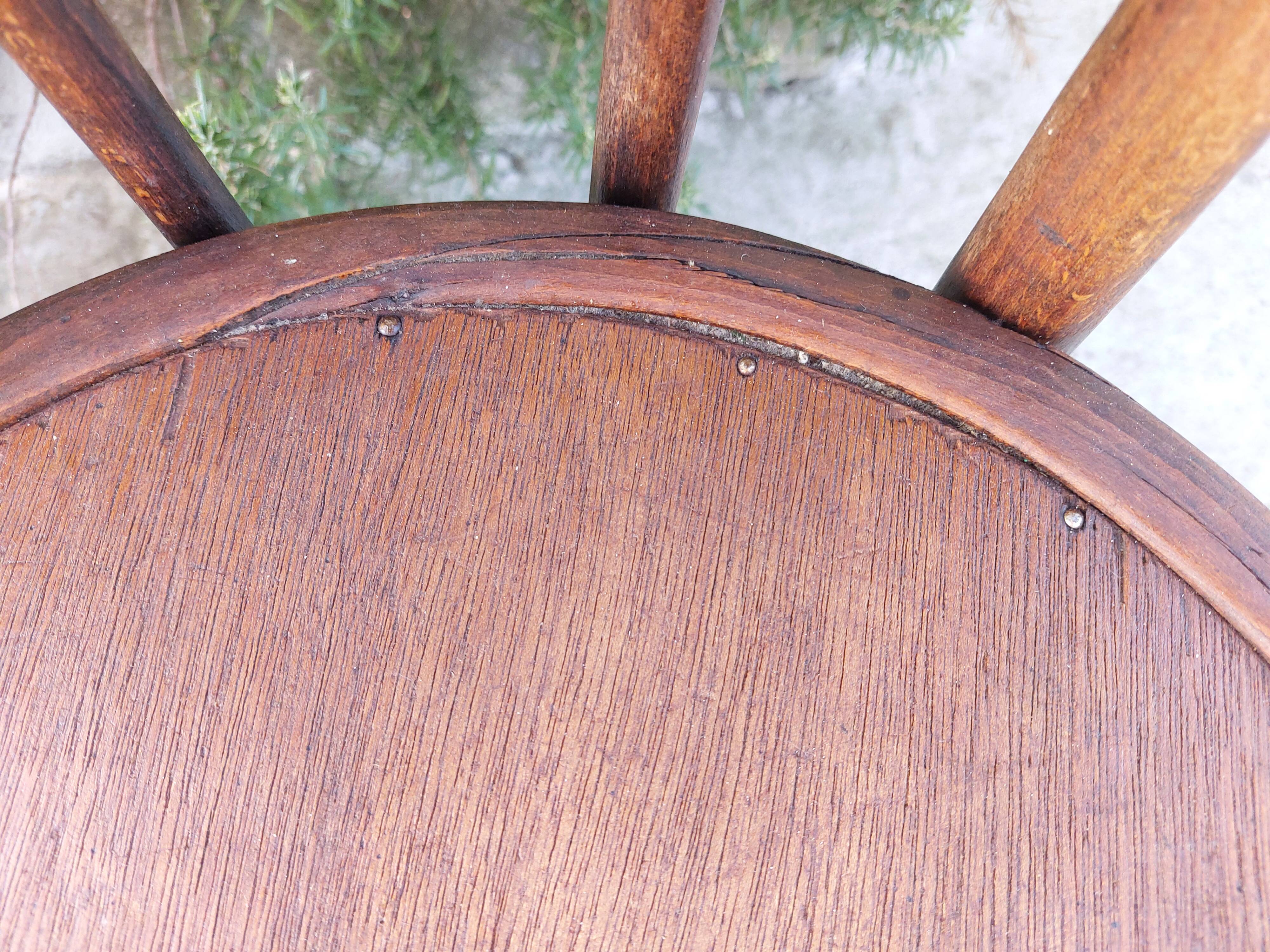 pair of round wooden chairs with a pattern on the seat