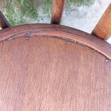 pair of round wooden chairs with a pattern on the seat