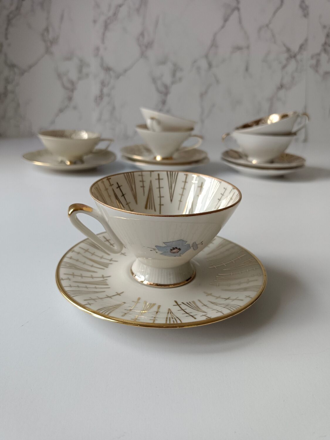 Set of mismatched fine porcelain cups signed with saucer